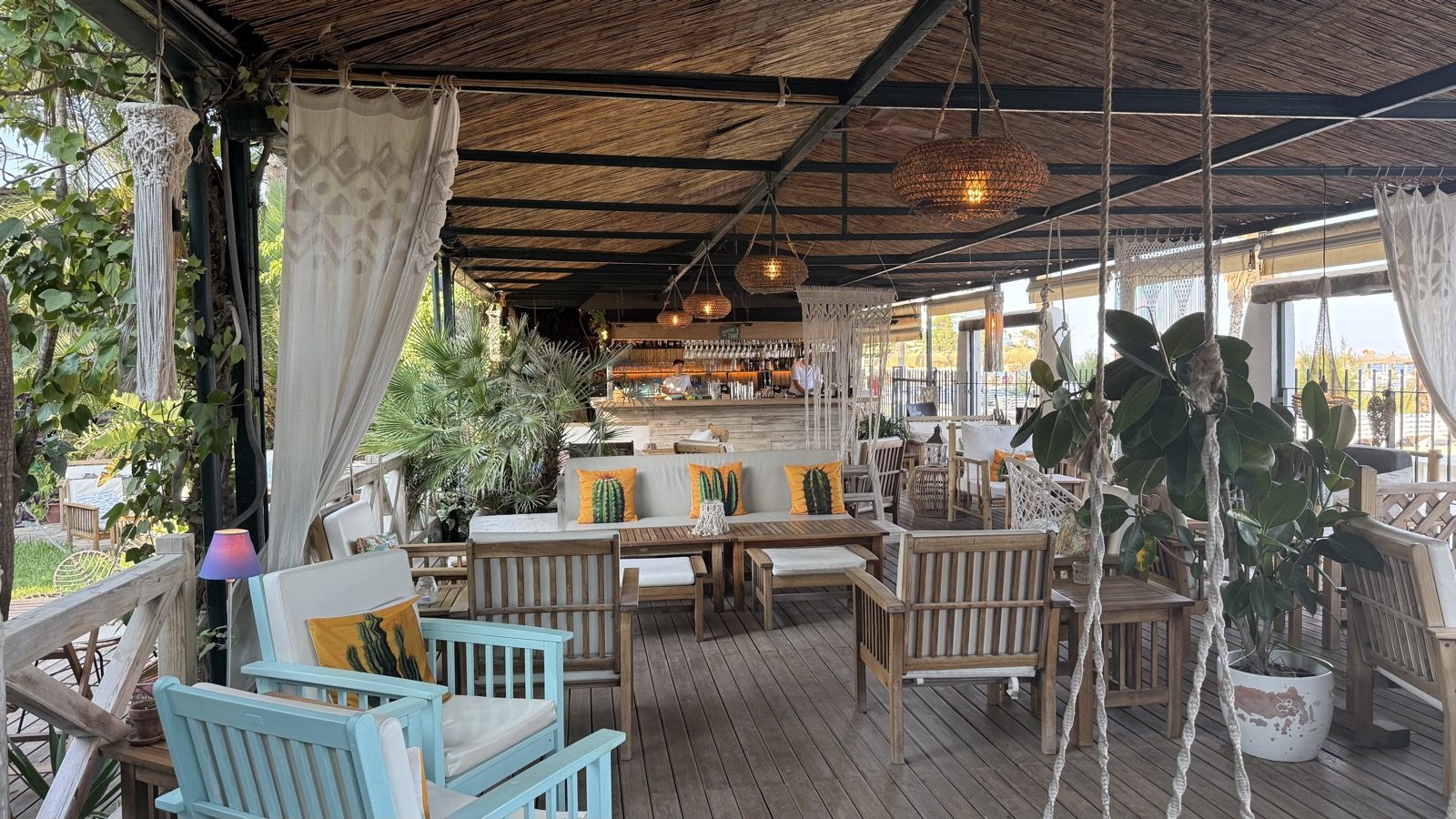 Covered terrace lounge with cushions and drapes